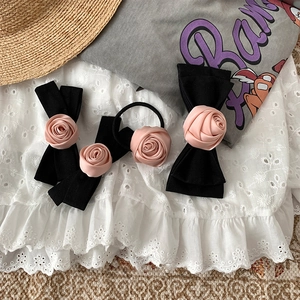 Three-piece set of black bow hair clips and scrunchie with pink satin rose flowers