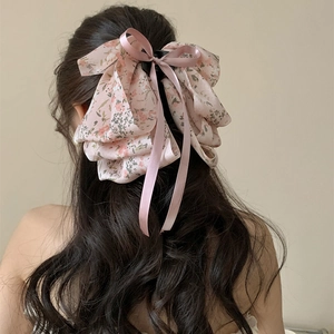 Romantic floral ribbon hair claw clip for women's bun hairstyle with pink bow detail