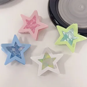 Star-shaped acetate hair clips set in pink, blue, white, and green marble textures