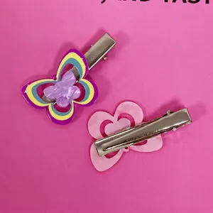 Colorful Y2K butterfly hair clips in pink and purple acrylic on pink background