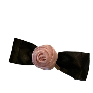 Pink fabric rose and black satin bow hair clip accessory for elegant women hairstyle