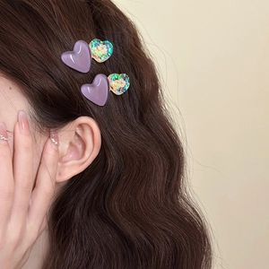 Cute purple heart hair clips set shown on model for elegant side bangs styling