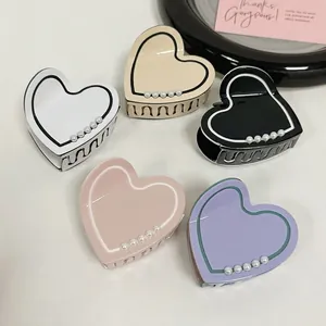 Elegant heart-shaped hair claw clips set with white pearls in five pastel colors