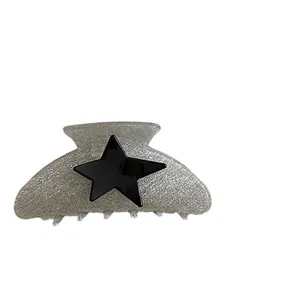 Sparkly silver acetate hair claw with a black star design for y2k aesthetic hairstyles
