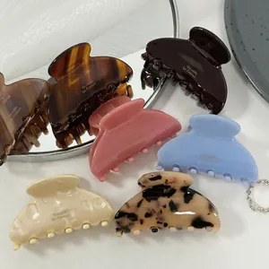 Elegant cellulose acetate hair claw clips in assorted candy colors with gold branding