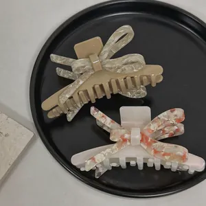 Pince à cheveux élégante en acétate avec motif de nœud papillon marbré 3D