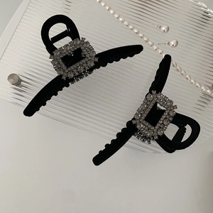 Detail view of premium black velvet hair claws with sparkling square rhinestone accents