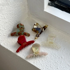 Five-piece acetate hair claw clips set in red, pearl pink, white and tortoiseshell