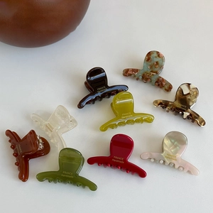 Macro shot of colorful handmade acetate hair clips with golden France handmade lettering