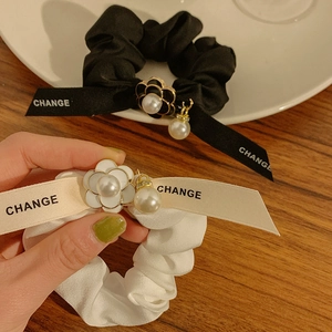 Elegant satin bow scrunchies with camellia flower and pearl charms in black and cream
