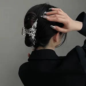 Silver liquid metal butterfly hair claw clip for women on elegant black updo hairstyle