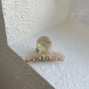 Detail of pearlescent acetate hair claw clip with golden France Handmade engraving