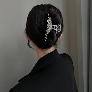 Detailed view of silver liquid metal butterfly claw clip for securing hair updo