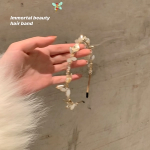 Detail of elegant floral pearl headband with translucent petals on a slim metal frame