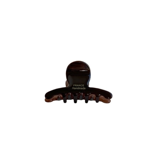 Deep brown tortoise acetate hair claw clip with golden France Handmade logo lettering