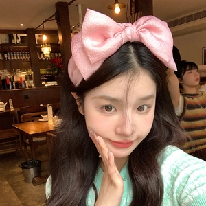 Pink oversized bow headband in premium satin, elegant hair accessory for women