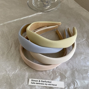 Minimalist padded sponge headbands in cream colors with textured fabric finish
