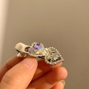 Close-up of Y2K hair clip with double heart rhinestones and shiny crystals