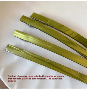 Detailed macro view of olive green pearlescent resin barrette clips with marble texture