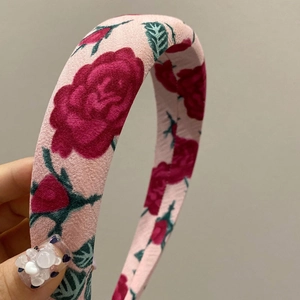 Pink floral headband with red rose pattern and wide brim fabric design for women