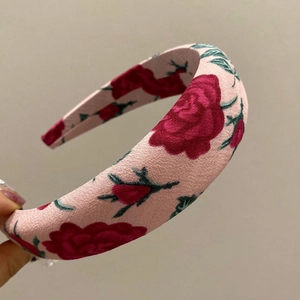 Floral wide headband with red roses and pink fabric base for elegant hair styling