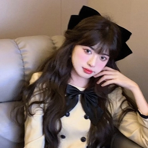 Elegant oversized black velvet bow hair clip worn by a model for a classic feminine look