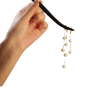 Elegant black wood hair stick with gold accents and dangling white pearl tassels