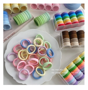 Macro detail of high-elasticity hair ties set in various pastel and earth colors