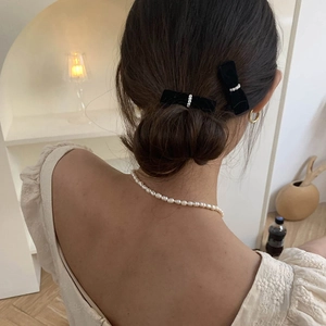 Exquisite black velvet bow hair clips with white pearls for women on model back view