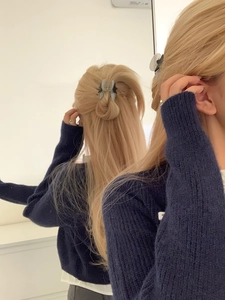 Close-up of a blue-gray star hair claw clip holding a high ponytail for Y2K styling