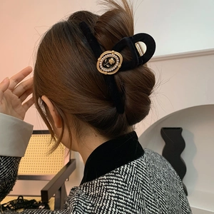 Retro black velvet hair claw clip with golden rose and pearls on hair for women