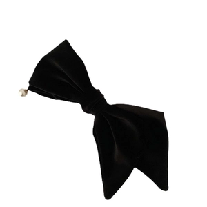 Elegante fermaglio per capelli in velluto nero con fiocco e perla bianca su sfondo bianco