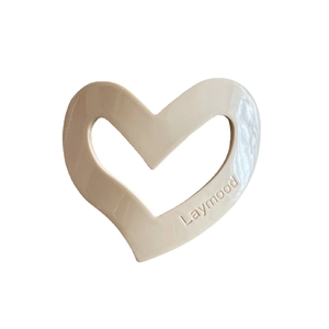 Minimalist cream heart-shaped hair clip by Laymood with polished irregular resin finish