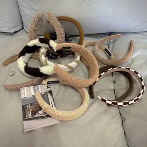 Brown and beige autumn plush wide headbands set with handmade tag on a fabric background