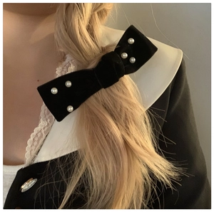 Elegant black velvet bow hair clip with white pearls for a French vintage hairstyle