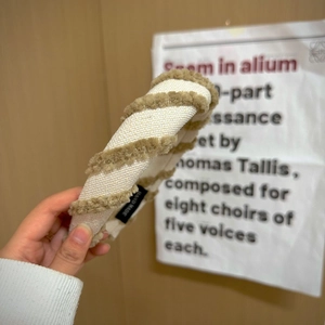 Detail of hand made wide sponge headband featuring beige woven fabric and brown plush stripes