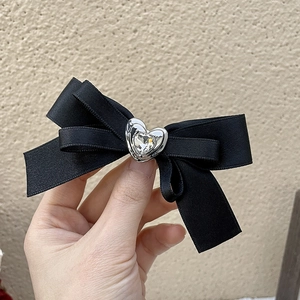 Elegant black satin bow hair clip with silver heart-shaped crystal center
