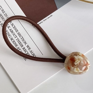 Coletero elástico marrón con decoración geométrica de acetato ámbar jaspeado