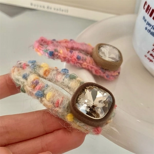 Knitted hair clip set with colorful pom-poms and square crystal embellishment
