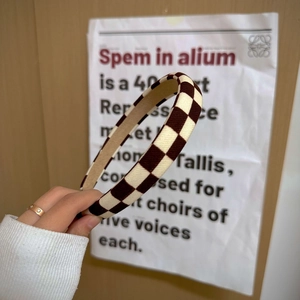 Detail of brown and beige checkerboard fabric headband with sponge padding for volume