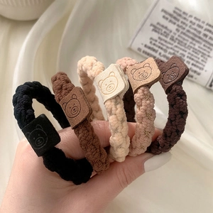 Five-pack set of woven elastic hair ties in neutral tones with bear patch decoration