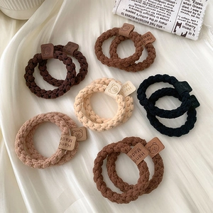 Detailed macro view of elastic knitted hair ties with bear pattern hand made labels