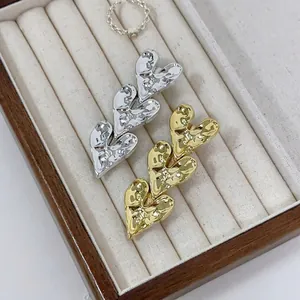 Chic heart-shaped metal hair clips in gold and silver with textured hammered surface finish