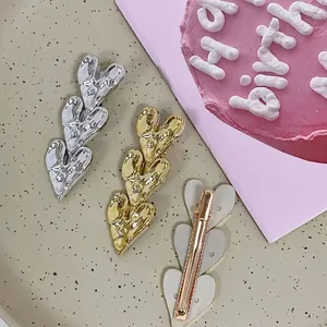 Sweet triple heart hair clips in gold and silver with lava metal texture for women