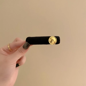 Elegant black velvet bow hair scrunchie with a gold metallic button for women ponytail