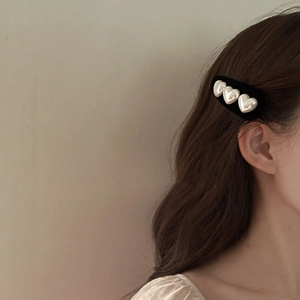 Vintage velvet hair clip with heart pearls shown on brunette hair for elegant styling