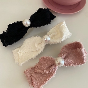Pink, black, and white tweed bow hair clips with large pearl accents for women