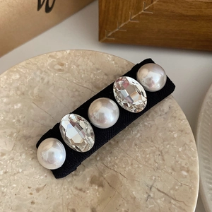 Detailed view of luxury French hair clip with alternating pearls and sparkling crystals