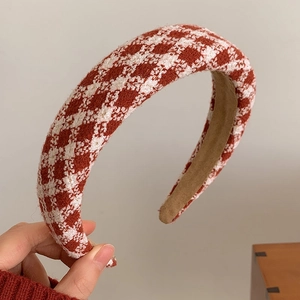 Close-up of red and white woven tweed headband featuring soft khaki suede inner lining