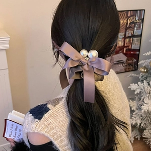 Elegant silk bow scrunchie with large white pearls for women in soft champagne pink